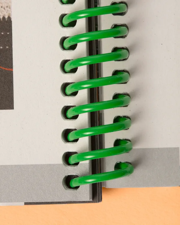Detailansicht eines Buchs mit Spiralbindung und glanzcellophaniertem Cover für erhöhte Haltbarkeit
